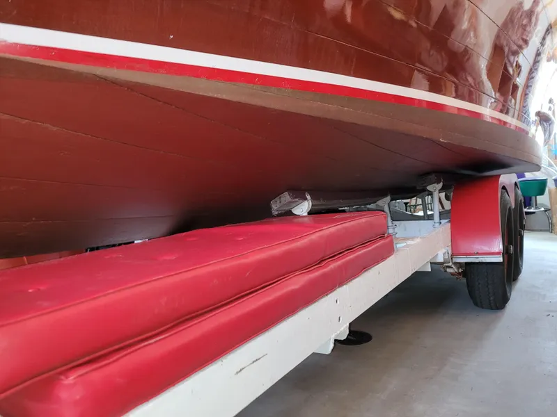 Slide: The Image of 1953 Chris-Craft HOLIDAY 24 boat on a trailer with red padding. - 13