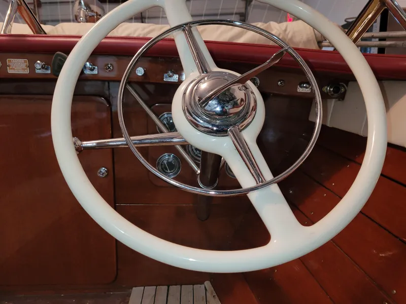 Slide: The Image of 1953 Chris-Craft HOLIDAY 24 steering wheel and dashboard, classic wooden boat interior. - 22