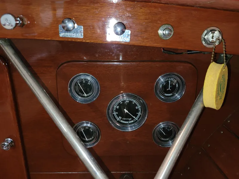 Slide: The Image of 1953 Chris-Craft HOLIDAY 24 dashboard with vintage gauges and wooden paneling. - 23