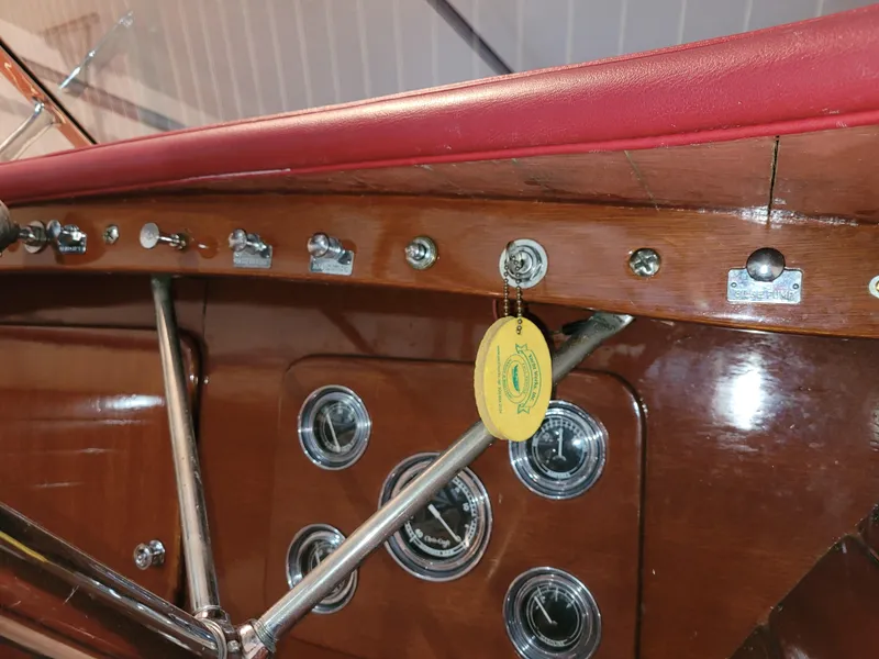 Slide: The Image of 1953 Chris-Craft HOLIDAY 24 boat dashboard with vintage gauges and controls. - 25