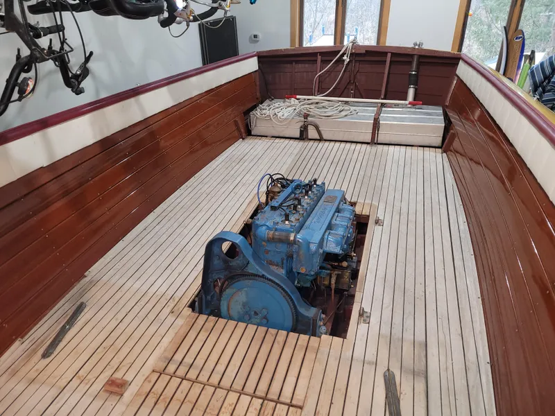 Slide: The Image of 1953 Chris-Craft HOLIDAY 24 boat interior with exposed engine and wooden deck. - 34