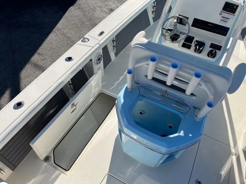 Slide: The Image of 2023 Pathfinder 2700 Open boat interior with helm, rod holders, and storage compartments. - 11