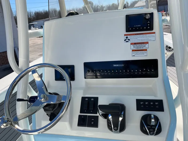 Slide: The Image of 2023 Pathfinder 2700 Open boat console with steering wheel and controls. - 14