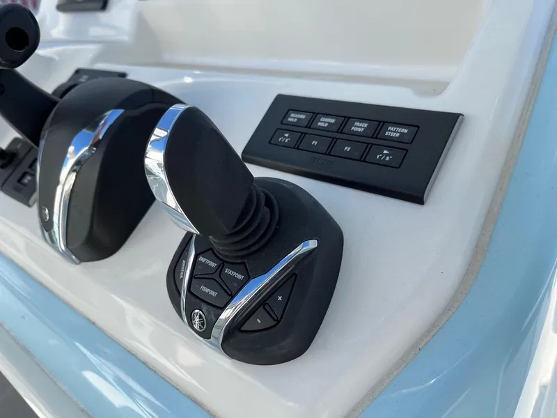 Slide: The Image of Pathfinder 2700 Open 2023 boat control panel with joystick and buttons. - 15