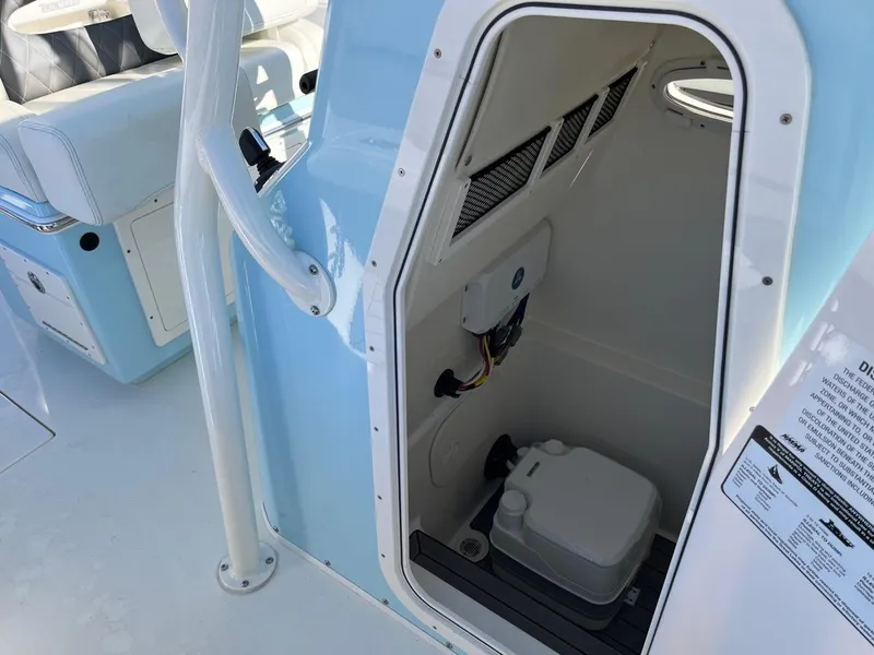 Slide: The Image of 2023 Pathfinder 2700 Open boat interior with a small cabin and portable toilet. - 18