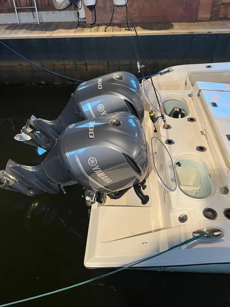 Slide: The Image of 2016 Cobia 296 CC boat with twin Yamaha 300 outboard engines docked. - 3