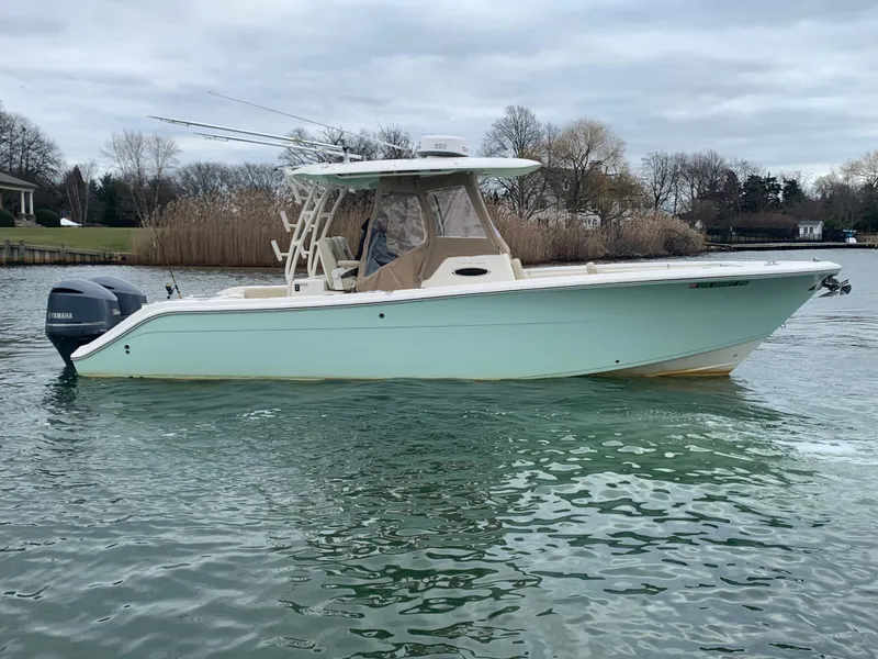 Slide: The Image of 2016 Cobia 296 CC center console boat on calm water. - 6