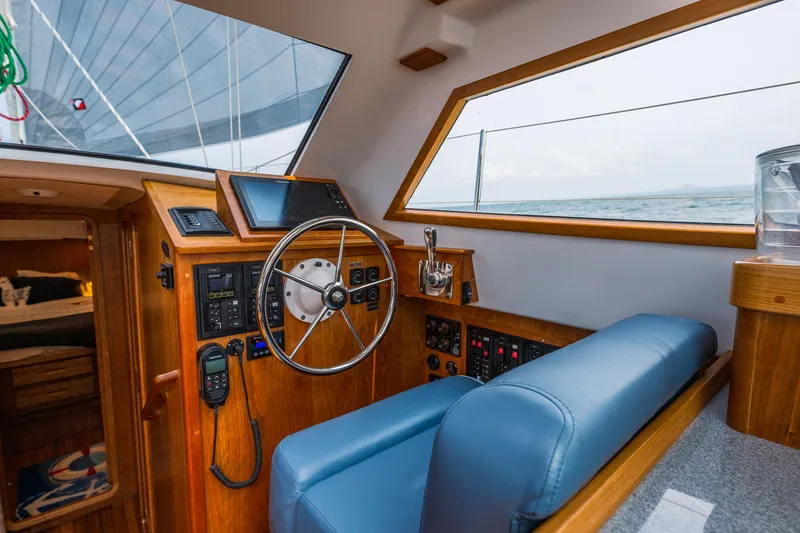 Slide: The Image of Interior of 2025 Tartan 455 sailboat cockpit with steering wheel and navigation equipment. - 10