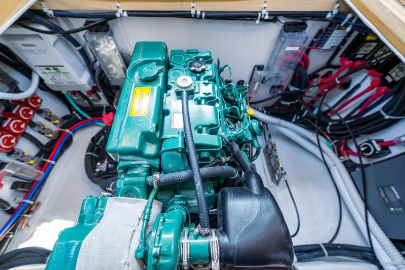 Slide: The Image of Engine compartment of a 2025 Tartan 455 sailboat with green engine and wiring. - 22