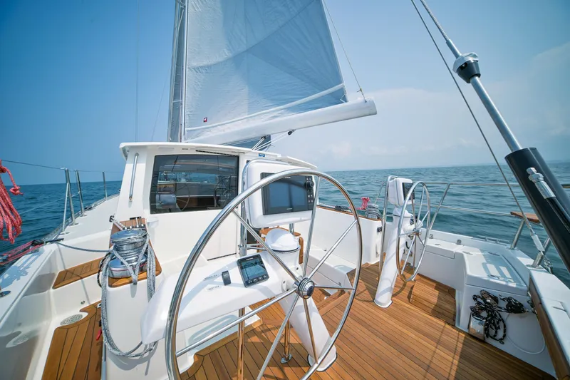 Slide: The Image of Modern Tartan 455 sailboat cockpit with dual steering wheels, 2025 model, sailing on open water. - 4