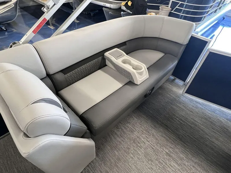 Slide: The Image of 2023 Godfrey SW 2286 MT boat interior with grey cushioned seating and cup holders. - 10