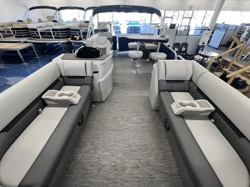 Slide: The Image of 2023 Godfrey SW 2286 MT pontoon boat interior with gray seating and cup holders. - 4