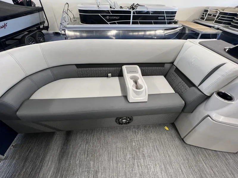 Slide: The Image of 2023 Godfrey SW 2286 MT boat interior with gray and white seating and cup holder. - 5