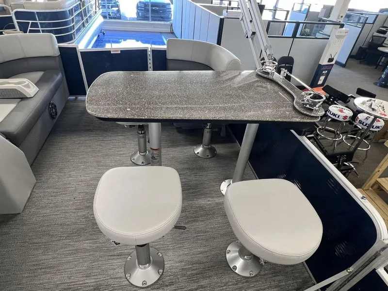 Slide: The Image of 2023 Godfrey SW 2286 MT boat interior with seating and table. - 9