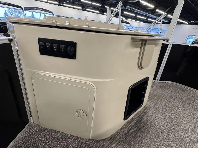 Slide: The Image of Control panel on a 2023 Godfrey SW 2286 FS boat, featuring switches and storage compartment. - 13