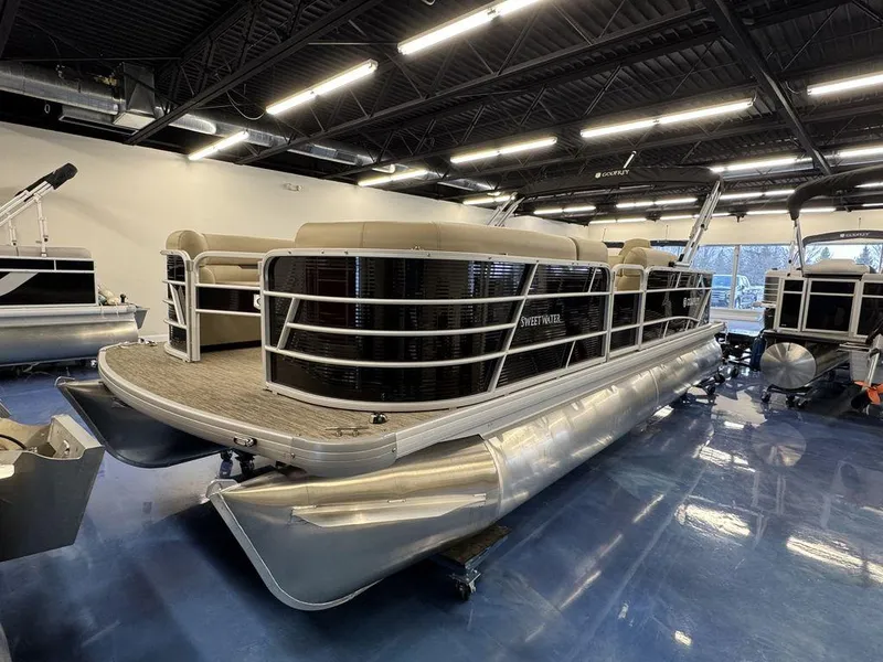 Slide: The Image of 2023 Godfrey SW 2286 FS pontoon boat displayed in a showroom. - 3