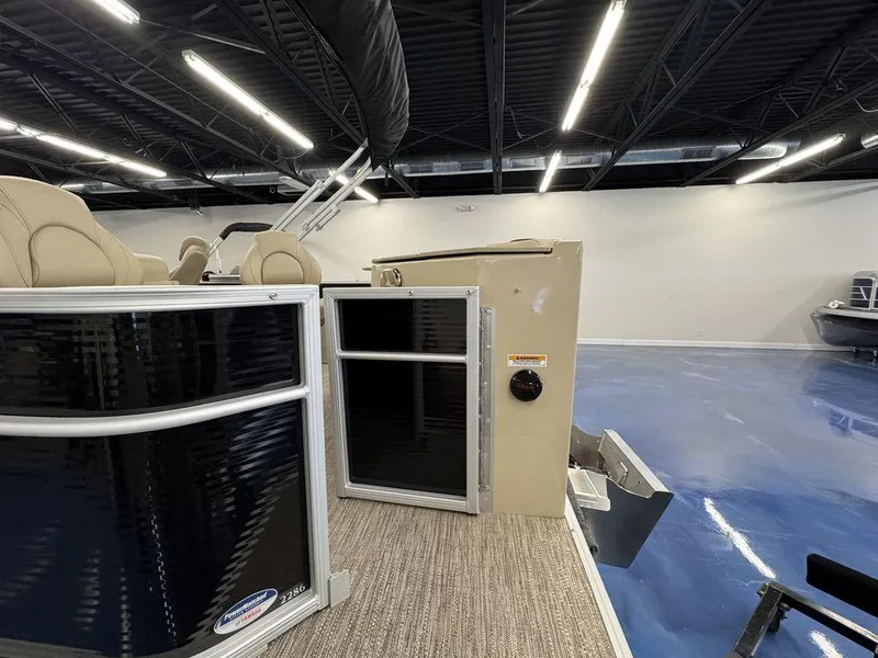 Slide: The Image of 2023 Godfrey SW 2286 FS pontoon boat interior with beige seating in showroom. - 4