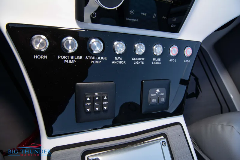 Slide: The Image of Control panel of a 2024 Fountain 34 Thunder Cat boat with various switches and buttons. - 34