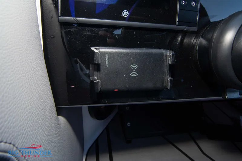 Slide: The Image of 2024 Fountain 34 Thunder Cat dashboard with wireless phone charger. - 37