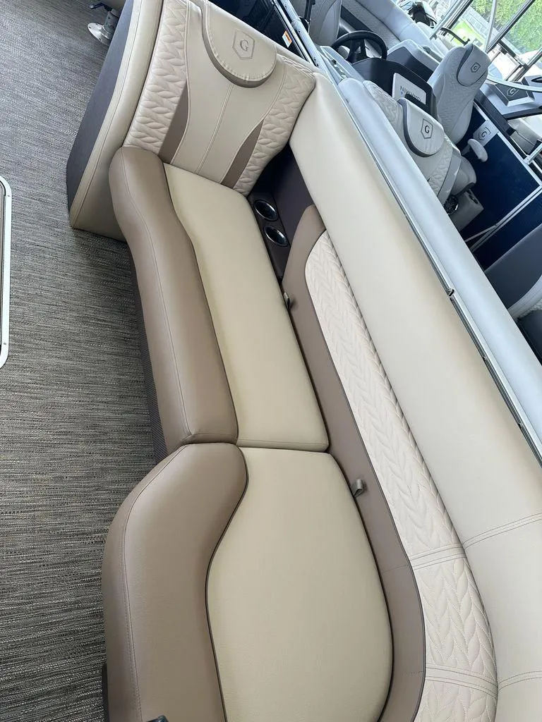 Slide: The Image of 2023 Godfrey MC 255 SFL boat interior with beige and brown seating. - 12