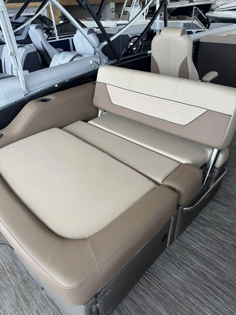 Slide: The Image of 2023 Godfrey MC 255 SFL boat interior with beige and brown seating. - 3