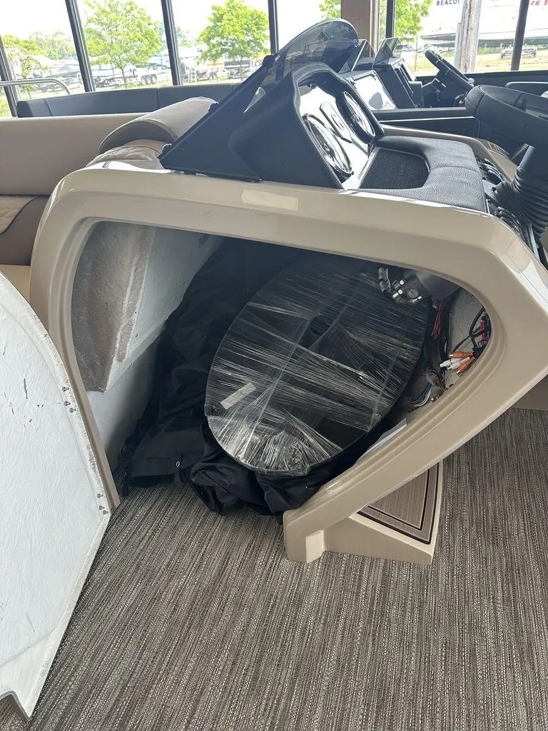 Slide: The Image of 2023 Godfrey MC 255 SFL boat interior with dashboard and storage compartment. - 7