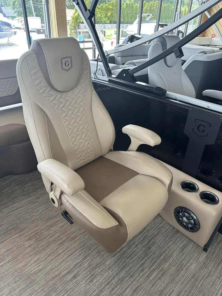 Slide: The Image of 2023 Godfrey MC 255 SFL boat captain's chair with beige upholstery and armrests. - 9