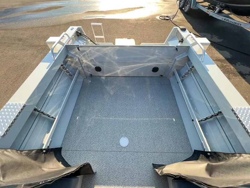 Slide: The Image of 2024 Hewescraft 200 Pro-V boat interior with spacious deck and storage compartments. - 13