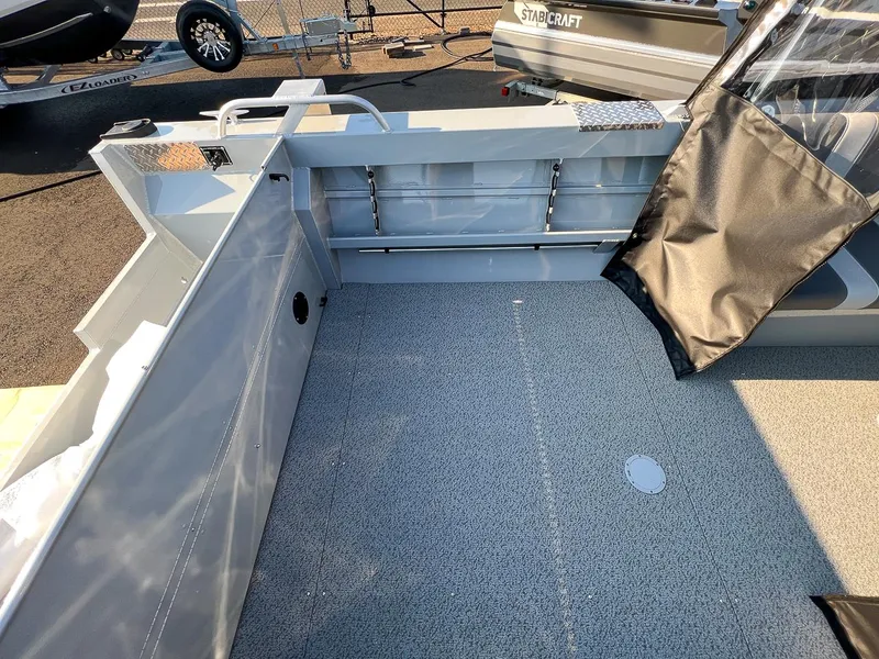 Slide: The Image of 2024 Hewescraft 200 Pro-V boat interior with gray flooring and storage compartments. - 14