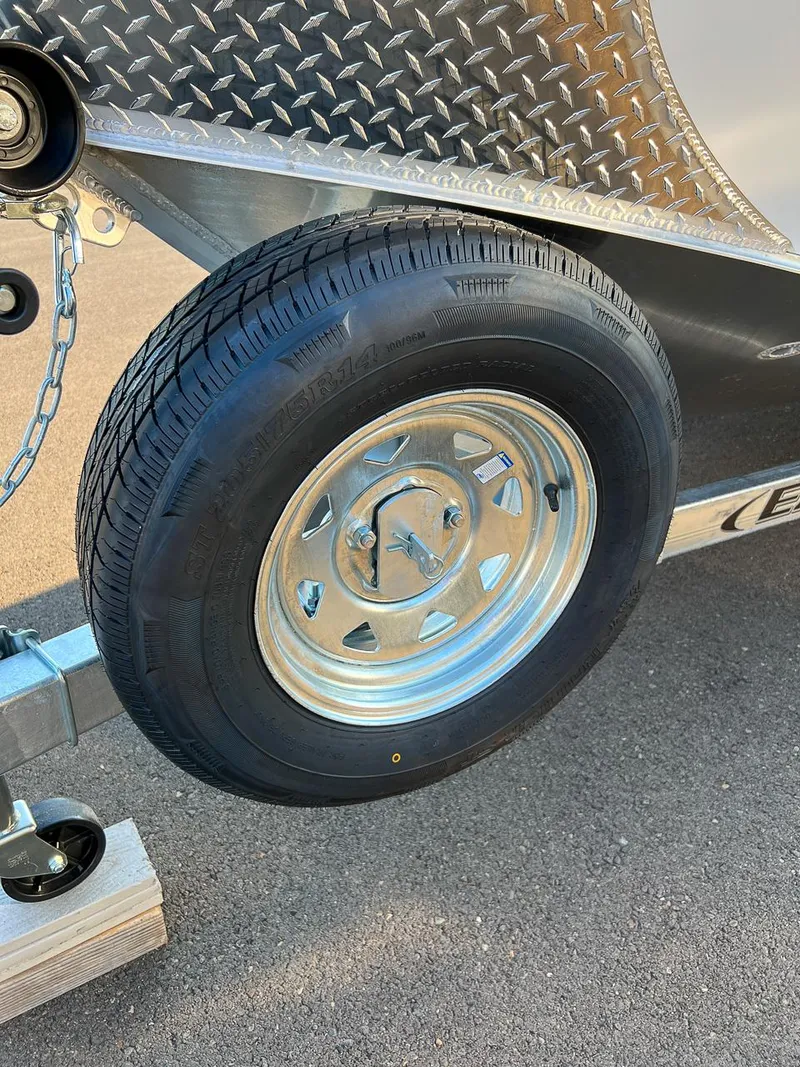 Slide: The Image of Close-up of a 2024 Hewescraft 200 Pro-V trailer tire and diamond plate fender. - 17