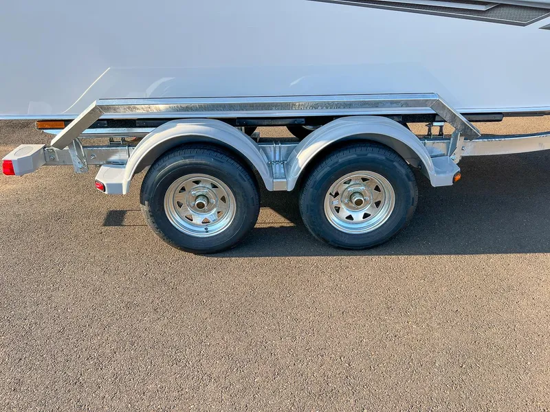 Slide: The Image of 2024 Hewescraft 200 Pro-V trailer with dual axles and shiny wheels. - 18