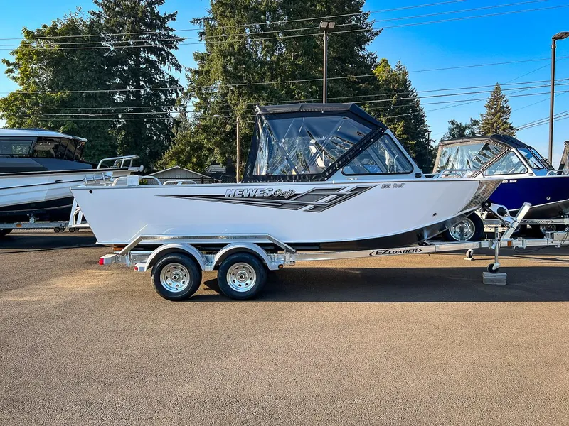 Slide: The Image of 2024 Hewescraft 200 Pro-V boat on a trailer in a dealership lot. - 2