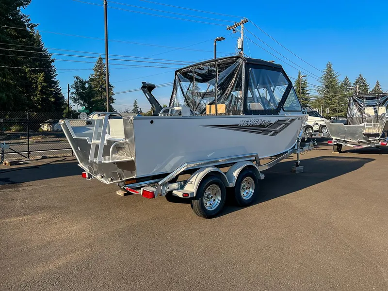 Slide: The Image of 2024 Hewescraft 200 Pro-V boat on a trailer in a parking lot. - 3