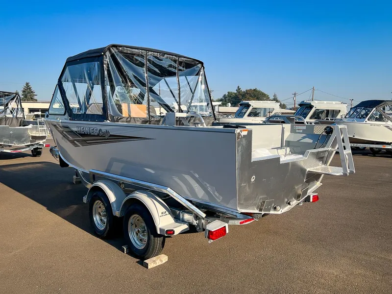 Slide: The Image of 2024 Hewescraft 200 Pro-V boat on a trailer in a dealership lot. - 5