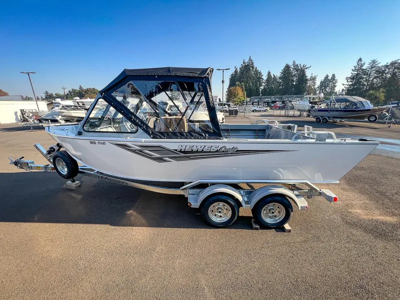Slide: The Image of 2024 Hewescraft 200 Pro-V boat on a trailer in a dealership lot. - 6
