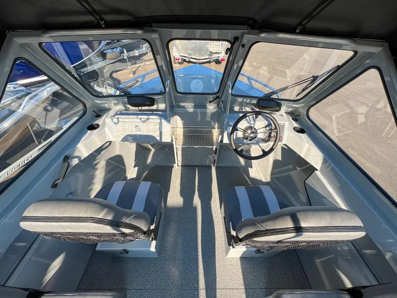 Slide: The Image of 2024 Hewescraft 200 Pro-V boat interior with steering wheel and seating. - 8