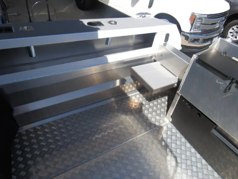 Slide: The Image of Interior of 2022 Stabicraft 2250 UltraCab WT boat with aluminum flooring and storage compartments. - 10