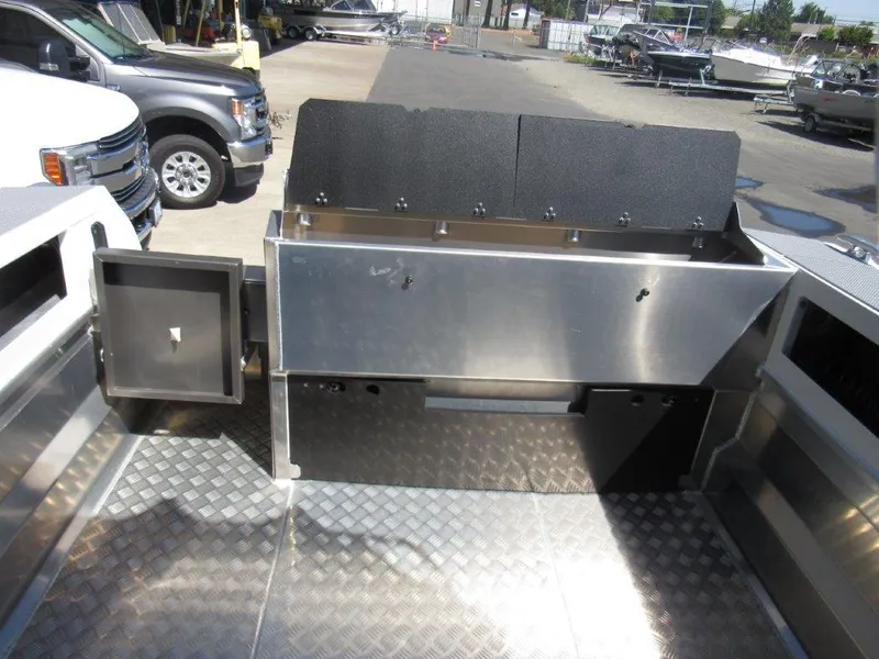 Slide: The Image of 2022 Stabicraft 2250 UltraCab WT deck with storage compartments and diamond plate flooring. - 11