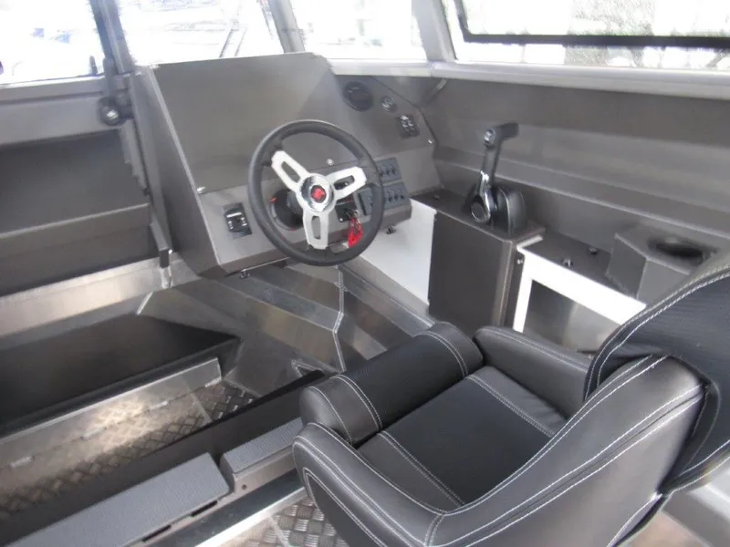 Slide: The Image of 2022 Stabicraft 2250 UltraCab WT interior cockpit with steering wheel and control panel. - 12