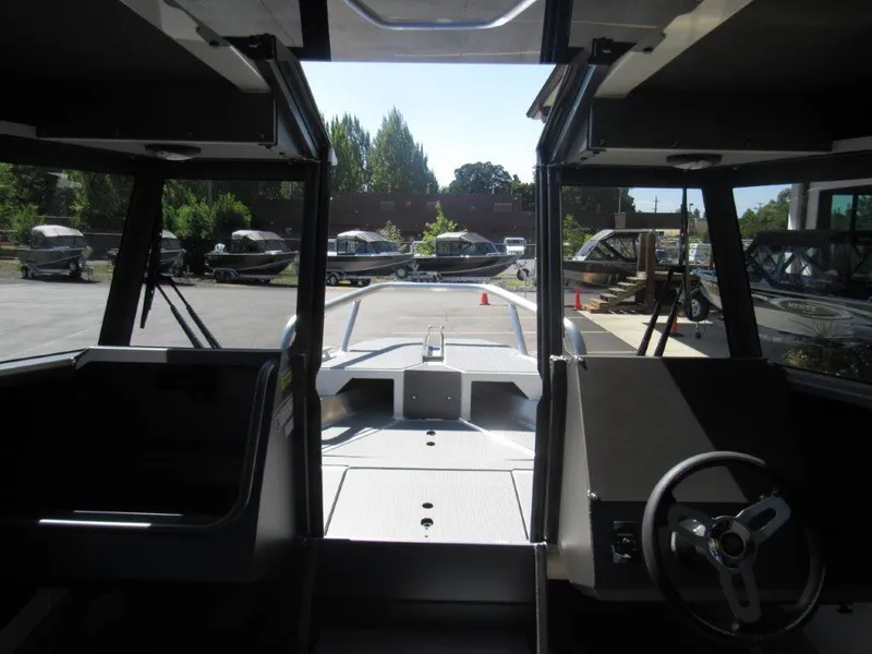 Slide: The Image of Interior view of 2022 Stabicraft 2250 UltraCab WT boat, showcasing helm and seating area. - 16