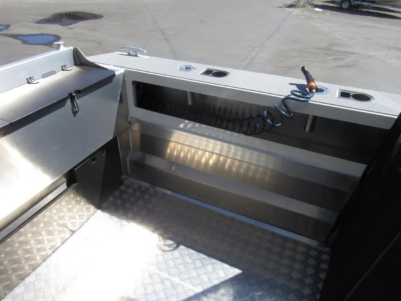 Slide: The Image of 2022 Stabicraft 2250 UltraCab WT interior with storage compartments and coiled hose. - 9