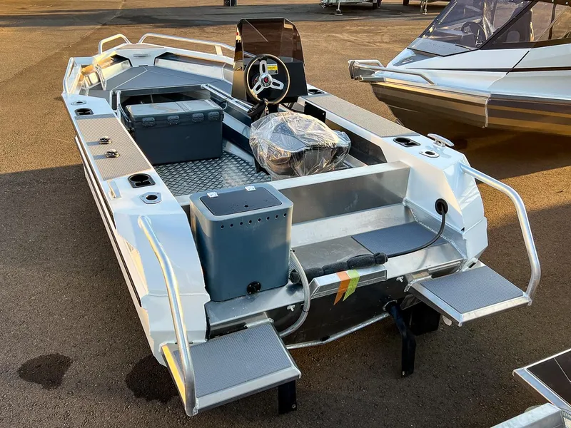 Slide: The Image of 2025 Stabicraft 1450 Frontier Profish boat, rear view, docked on pavement. - 3