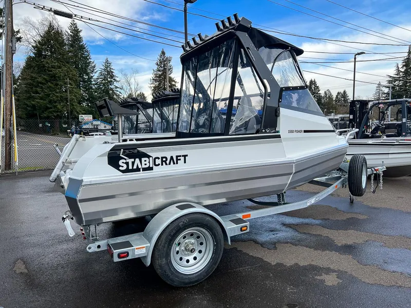 Slide: The Image of 2024 Stabicraft 1550 Fisher boat on a trailer, parked outdoors. - 3