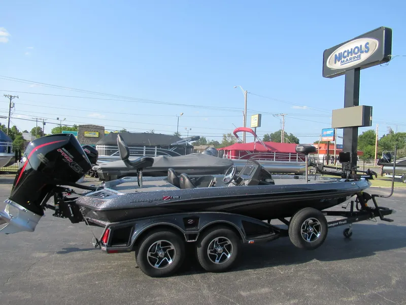 Slide: The Image of 2023 Ranger Z519 boat with motor, parked at Nichols Marine dealership. - 0