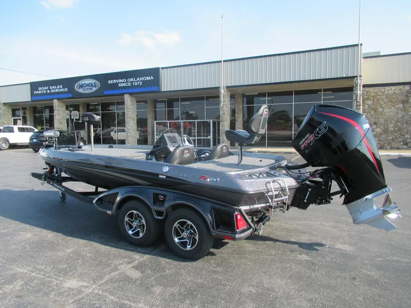 Slide: The Image of 2023 Ranger Z519 boat with trailer parked outside a dealership. - 1