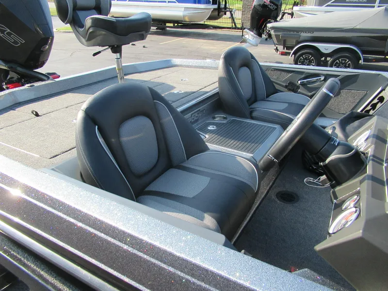 Slide: The Image of 2023 Ranger Z519 boat interior with dual seats and steering console. - 2