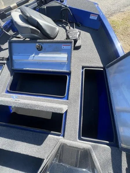 Slide: The Image of 2023 Crestliner XF 179 boat with open storage compartments and seating. - 8