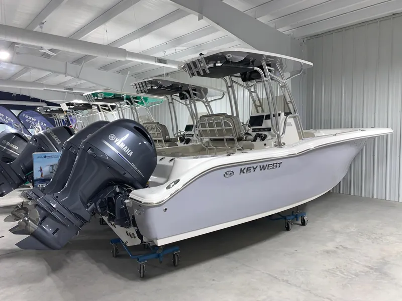 Slide: The Image of 2024 Key West 244 Center Console boat in showroom with Yamaha outboard engines. - 1