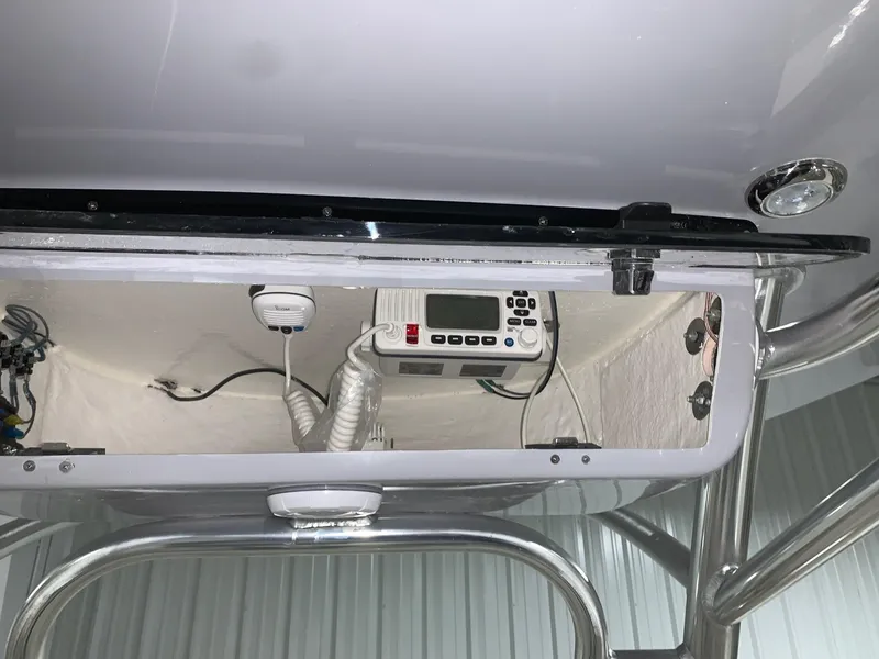 Slide: The Image of 2024 Key West 244 Center Console electronics compartment with radio and wiring. - 12