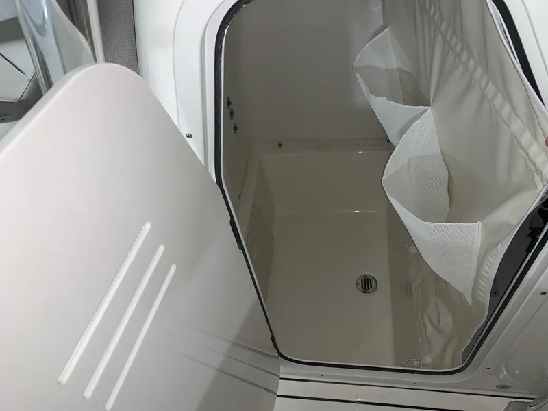 Slide: The Image of 2024 Key West 244 Center Console storage compartment with open hatch. - 13